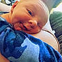 Waylen is registered to the contest to win money with this photo: arm, baby, blue, closeup, clothing, comfort, cuddle, face, human, indoor, infant, light, pattern, peaceful, person, portrait, resting, shoulder, skin, smile