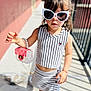 Leah joined the competition — help win amazing prizes! child, toddler, sunglasses, striped_clothing, top, skirt, shoes, sneakers, handbag, bracelet, sunny, outdoor, sidewalk, railing, posing, fashion, cute, person, portrait, young