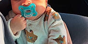 Jonass participe au concours pour gagner de l'argent avec cette photo : adult, baby, bear_pattern, car_interior, child, closeup, cozy, cute, hand, infant, onesie, pacifier, peaceful, person, portrait, resting, sleeping, soft, sunlight, warm