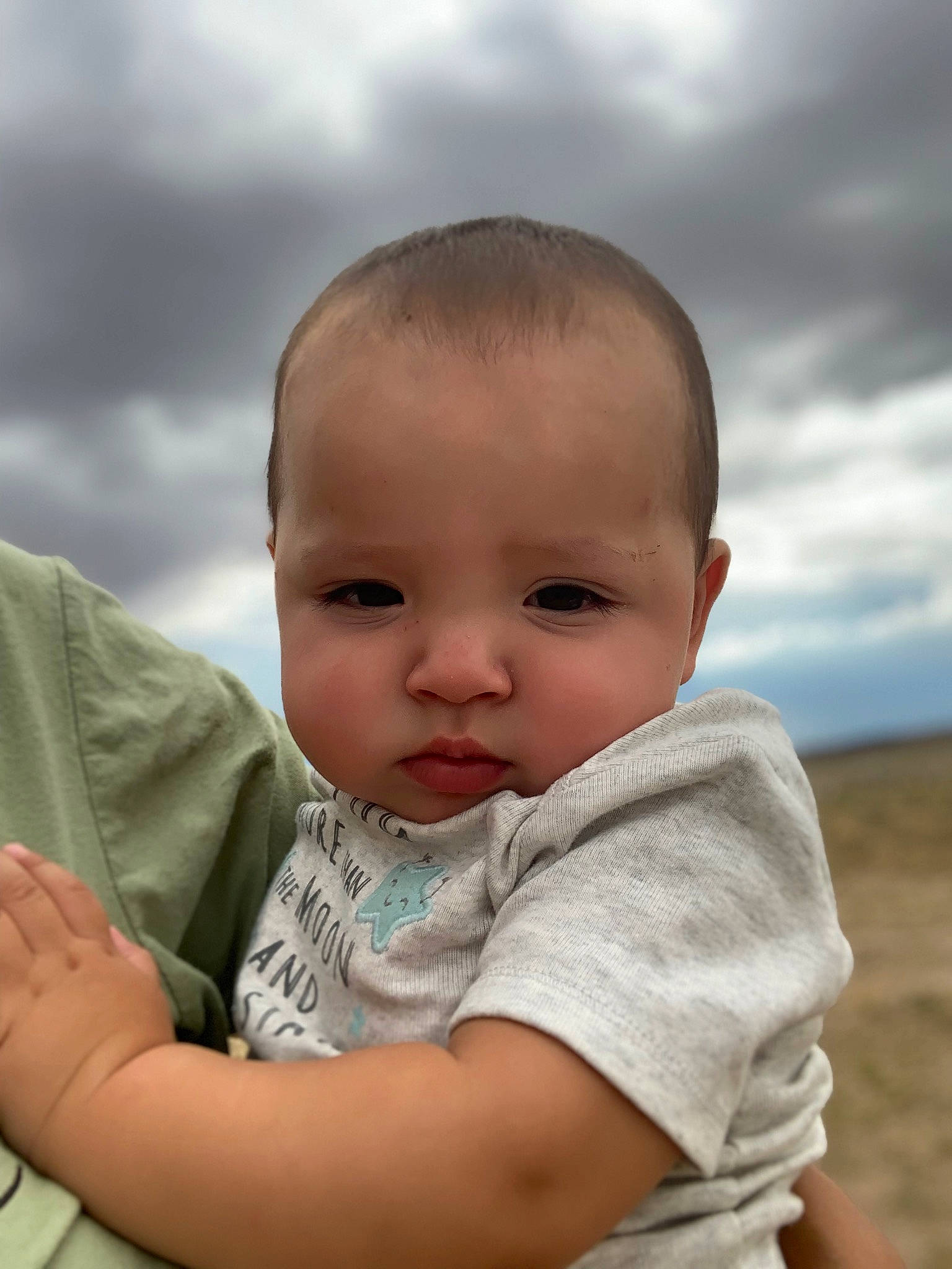 Gael is registered to the contest to win money with this photo: baby, baby_toddler_clothing, beauty, cheek, child, cloud, flash_photography, fun, gesture, grass, grassland, happy, people_in_nature, person, prairie, sitting, skin, sky, sleeve, t_shirt