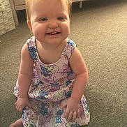 Kasey joined the competition — help win amazing prizes! toddler, child, smiling, red_hair, dress, cartoon_print, sitting, carpet, indoor, happy, cute, person, baby, young_child, playful, bright, toothy_grin, furniture, wooden_drawer, basket