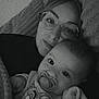 baby, woman, glasses, pacifier, blanket, cartoon, cat, clothing, face, cuddle, cozy, portrait, indoor, comfort, parent, child, snuggle, expression, black_and_white, relaxation