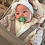 Mya a rejoint le concours — aidez-le/la à gagner de superbes lots ! baby, pacifier, headband, bow, car_seat, plush_toy, bunny, floral_clothing, fur_vest, straps, infant, child, cute, indoors, soft_toys, comfort, closeup, face, portrait, seat