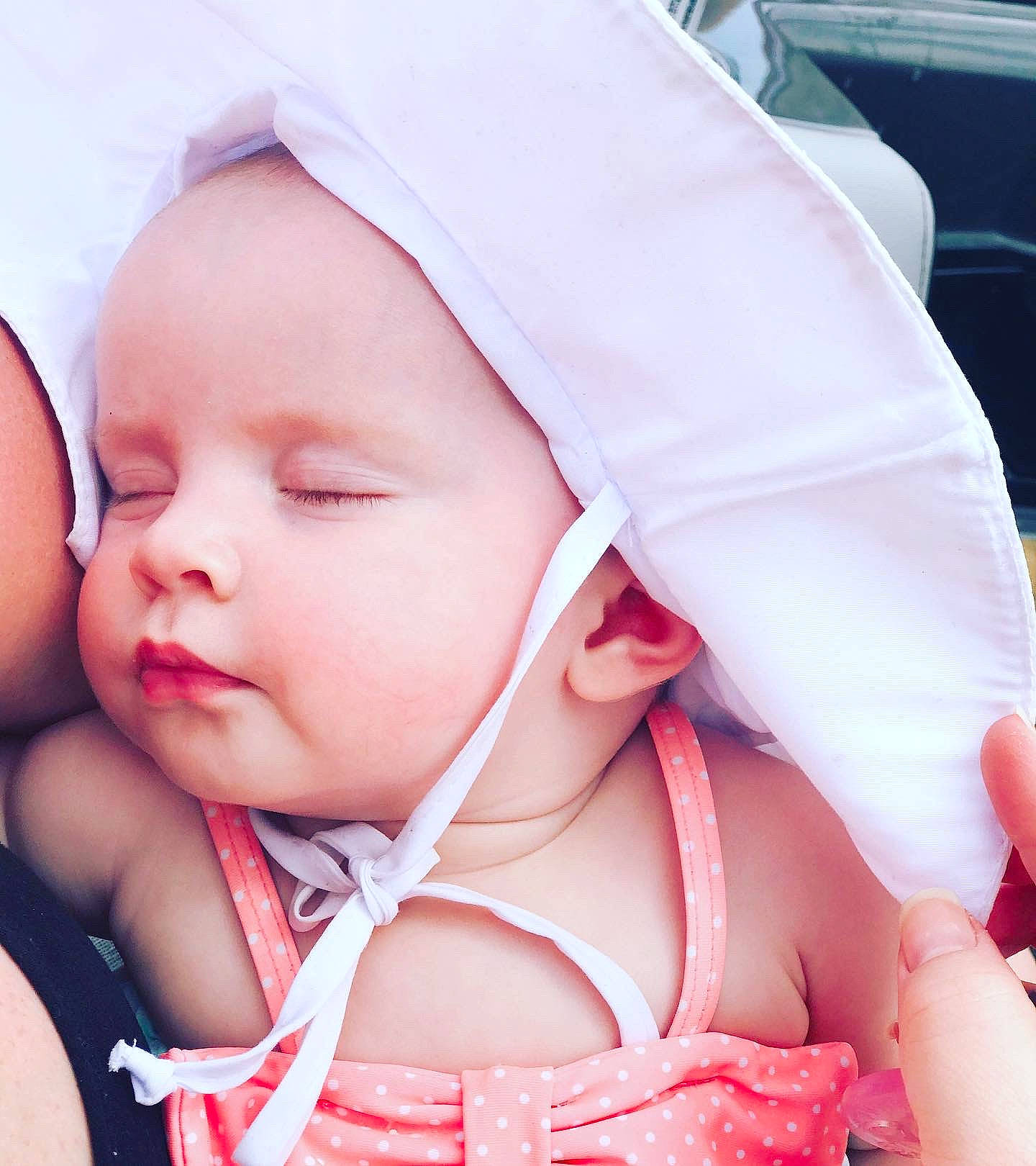 Tillie is registered to the contest to win money with this photo: baby, baby_products, baby_sleeping, bonnet, cheek, child, ear, face, happy, head, headgear, headwear, lip, mouth, nose, person, pink, product, skin, smile