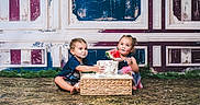 Reigna joined the competition — help win amazing prizes! child, toddler, cake, watermelon, food, messy, indoor, floor, playful, smiling, sitting, frosting, hands, face, blue_clothing, dress, basket, background, vintage_wall, happy