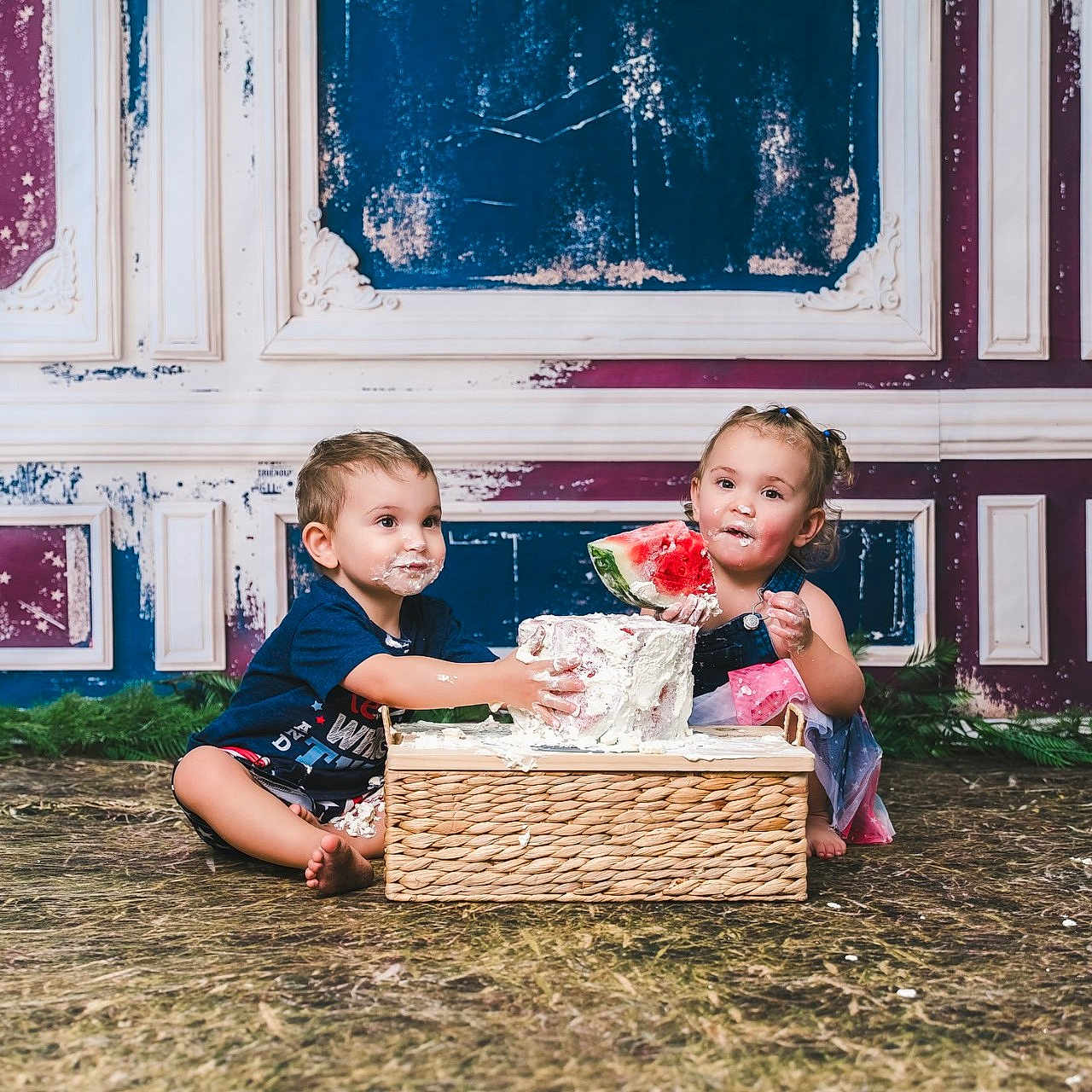 Reigna joined the competition — help win amazing prizes! child, toddler, cake, watermelon, food, messy, indoor, floor, playful, smiling, sitting, frosting, hands, face, blue_clothing, dress, basket, background, vintage_wall, happy