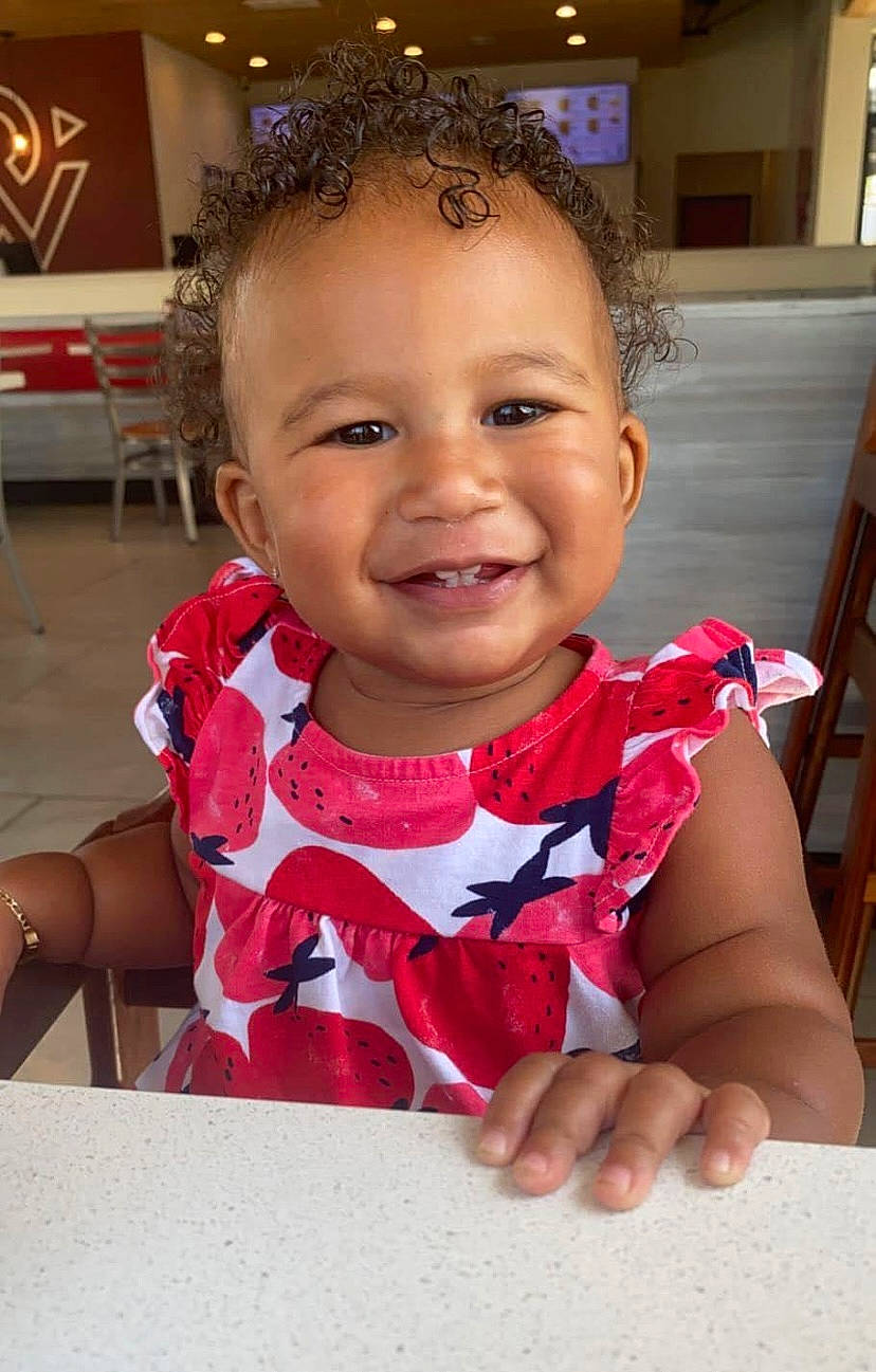 Kaliyah is registered to the contest to win money with this photo: baby, baby_toddler_clothing, cheek, child, event, eyelash, facial_expression, finger, fun, gesture, happy, head, iris, joy, lip, mouth, nose, person, skin, smile