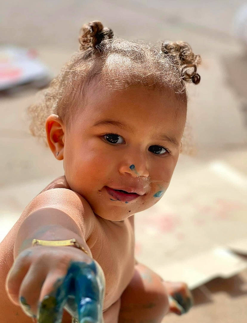 Kaliyah is registered to the contest to win money with this photo: baby, baby_toddler_clothing, chest, child, eye, eyelash, face, fashion_accessory, finger, flash_photography, fun, happy, head, headpiece, nail, nose, person, skin, smile, thumb