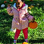 child, girl, pumpkin, pumpkin_patch, pink_jacket, pink_pants, grass, outdoor, fall, autumn, smiling, shoes, nature, greenery, sunlight, holding, standing, cute, happy, holiday