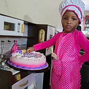 Moriah joined the competition — help win amazing prizes! child, baker, apron, chef_hat, birthday_cake, play_kitchen, pink_clothing, polka_dots, kitchen_toys, pretend_play, indoor, celebration, smile, person, food, decorations, colorful, young, girl, cute