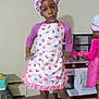 Elena joined the competition — help win amazing prizes! child, girl, apron, chef_hat, play, indoor, toy_kitchen, polka_dot, carpet, pretend_play, kitchen, pink, purple, cupcake_pattern, smile, pose, person, footwear, home, cute