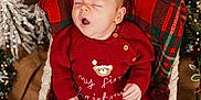 Caleb is registered to the contest to win money with this photo: baby, basket, berries, celebration, christmas, cozy, cute, decorations, festive, holiday, holiday_season, indoors, infant, knitwear, lights, pine_branches, plaid_blanket, red_clothing, sleepy, yawning