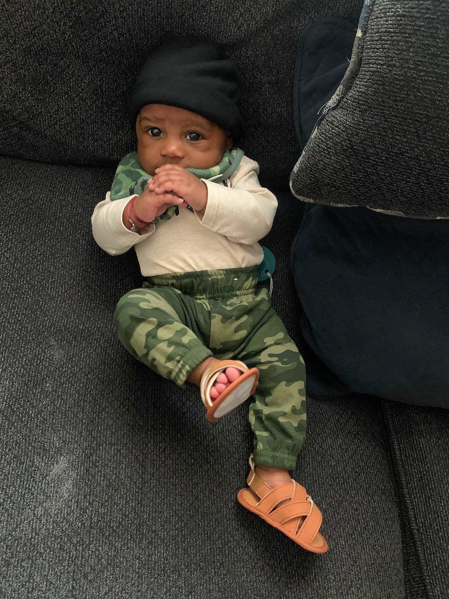Kenny is registered to the contest to win money with this photo: baby, baby_products, baby_toddler_clothing, beanie, bonnet, camouflage, comfort, foot, headwear, knit_cap, person, sock, toddler