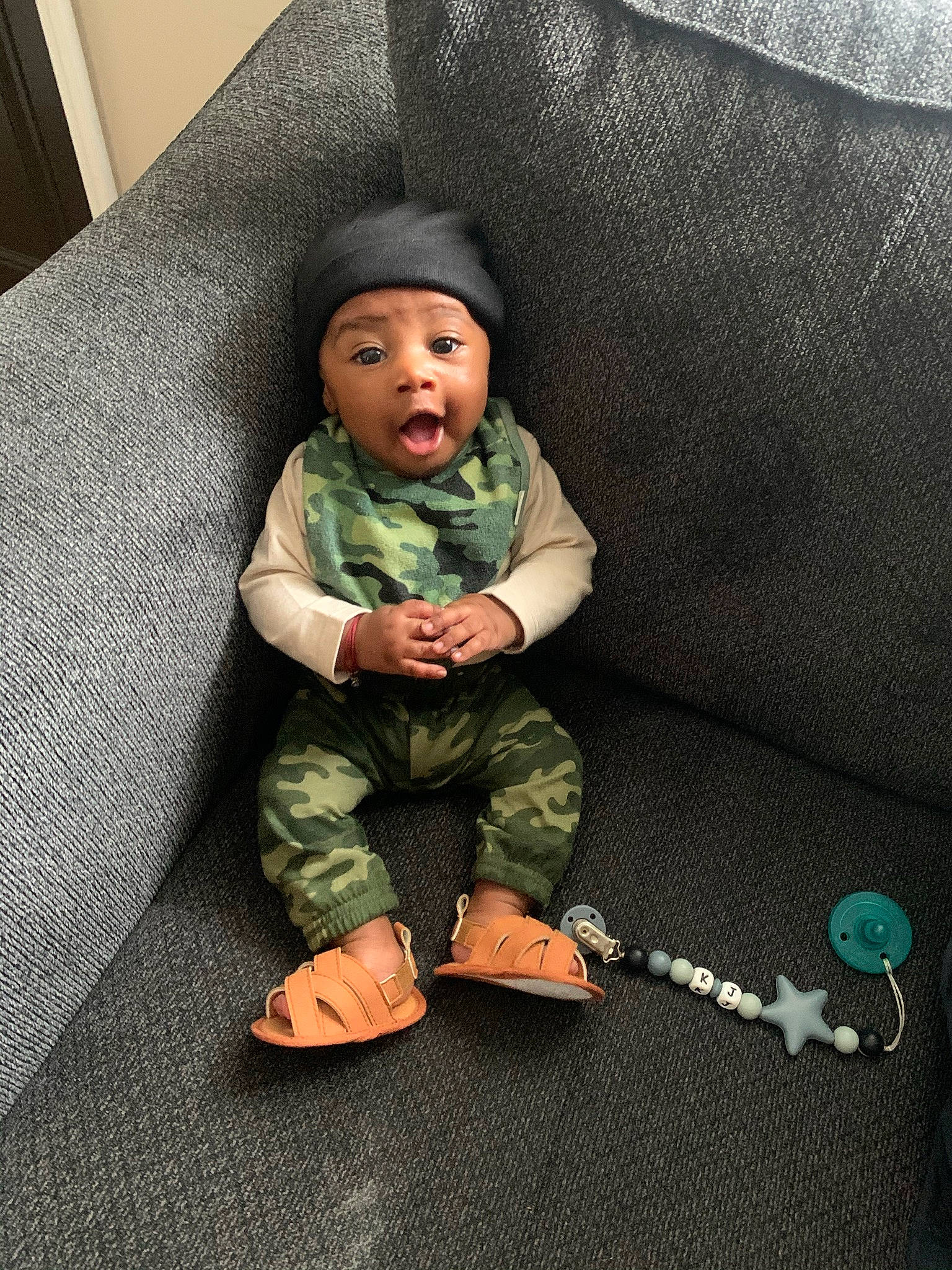 Kenny joined the competition — help win amazing prizes! baby, baby_toddler_clothing, comfort, couch, foot, headwear, person, sock, surprise, teal, toddler, turquoise