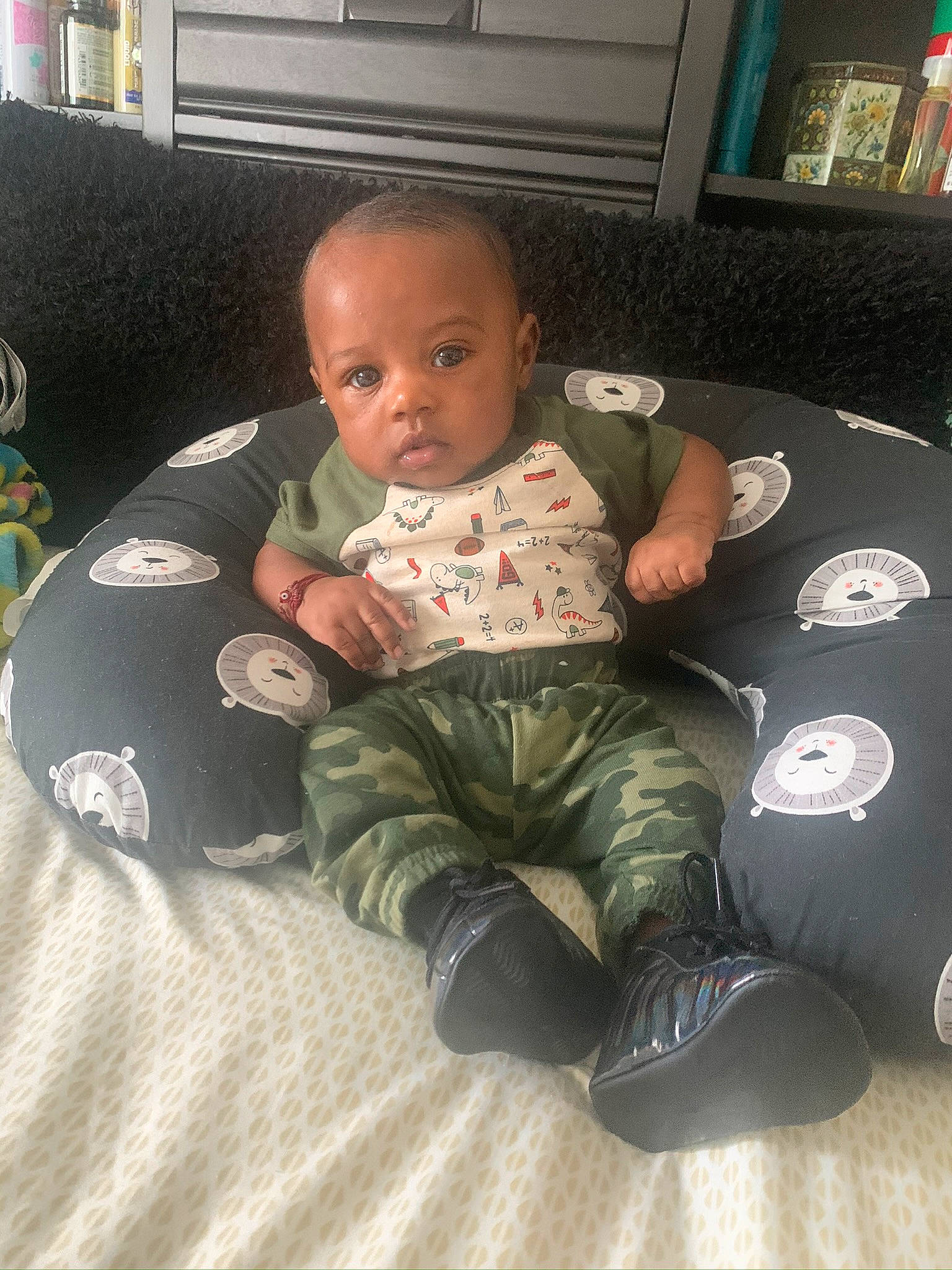 Kenny is registered to the contest to win money with this photo: baby, baby_toddler_clothing, comfort, home, home_accessories, human_body, lamp, lap, linens, living_room, person, room, sitting, sock, toddler