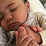 Miguel is registered to the contest to win money with this photo: baby, child, closeup, comfort, cozy, cute, face, family, hand, holding, indoor, infant, love, pajamas, peaceful, person, resting, skin, sleeping, toddler