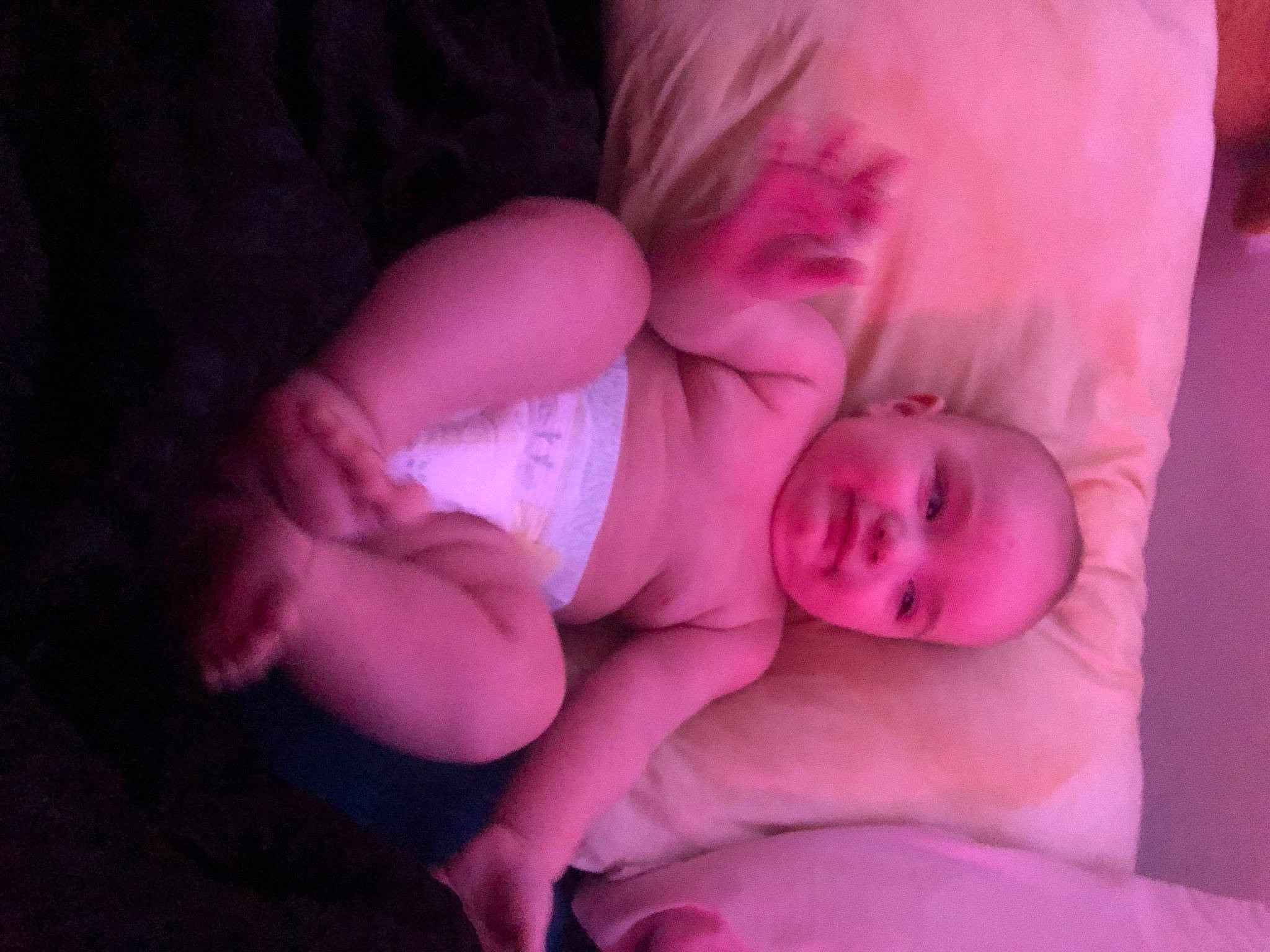 Lochlan is registered to the contest to win money with this photo: baby, baby_toddler_clothing, bedtime, child, comfort, darkness, dress, flash_photography, fun, gesture, human_body, linens, magenta, nail, nose, person, pink, purple, skin, toddler