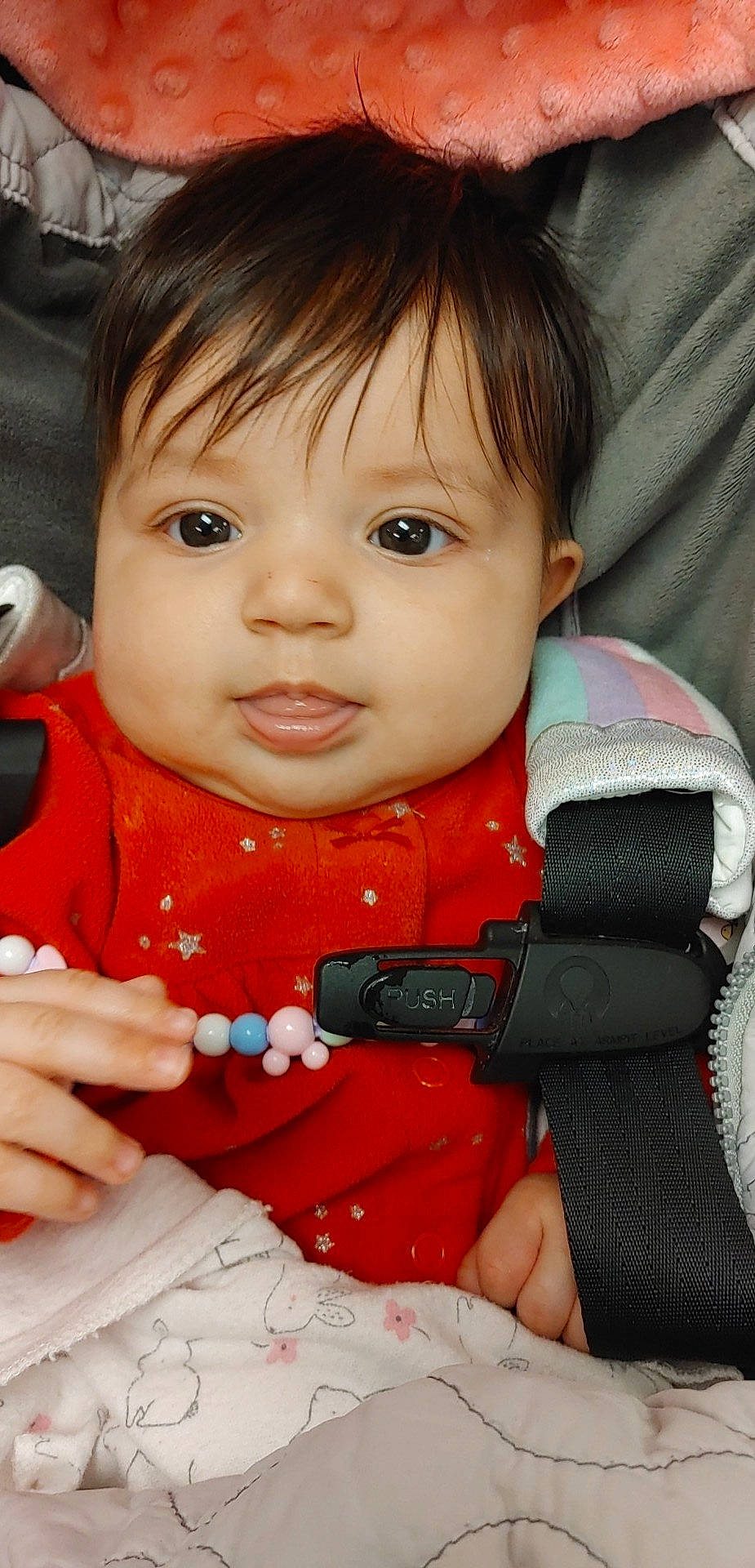 Delila is registered to the contest to win money with this photo: baby, baby_toddler_clothing, cheek, child, chin, eyelash, finger, fun, gesture, happy, iris, lip, mouth, nail, nose, pattern, person, skin, sleeve, thumb