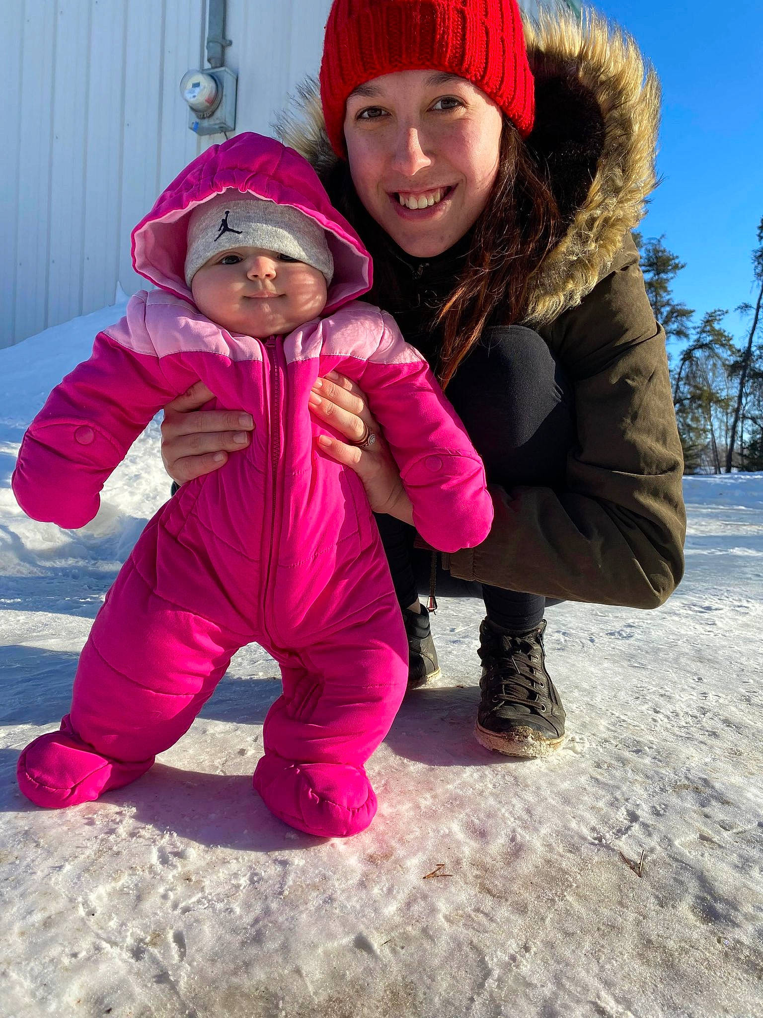 Delila is registered to the contest to win money with this photo: baby_toddler_clothing, eye, face, freezing, fun, gesture, happy, head, headgear, headwear, human_body, jacket, joy, leg, outerwear, people_in_nature, person, photograph, pink, purple