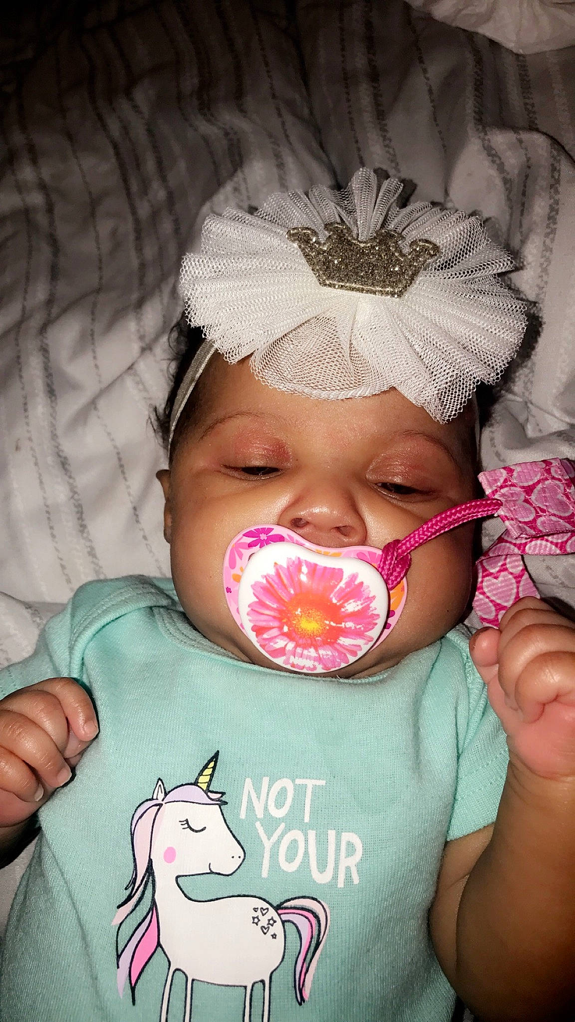 Layloni is registered to the contest to win money with this photo: baby, birth, cheek, child, eyelash, forehead, hair_accessory, hand, head, headgear, lip, mouth, nose, person, pink, skin, smile, toddler