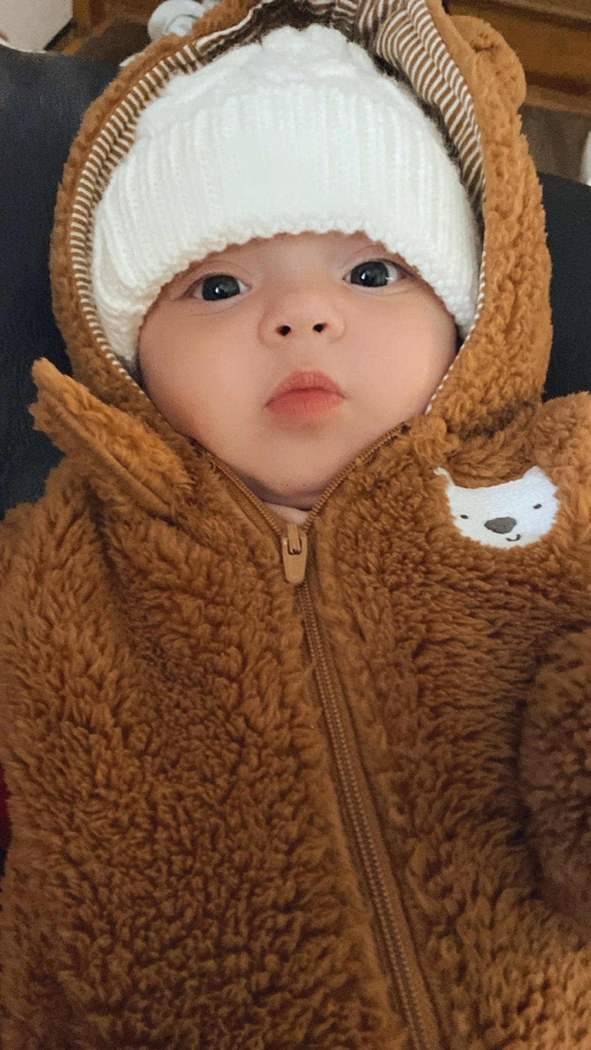 Aria is registered to the contest to win money with this photo: baby, baby_toddler_clothing, cap, cheek, child, eye, face, fur_clothing, headgear, jacket, lip, mammal, nose, outerwear, skin, sleeve, textile, toddler, wool, woolen