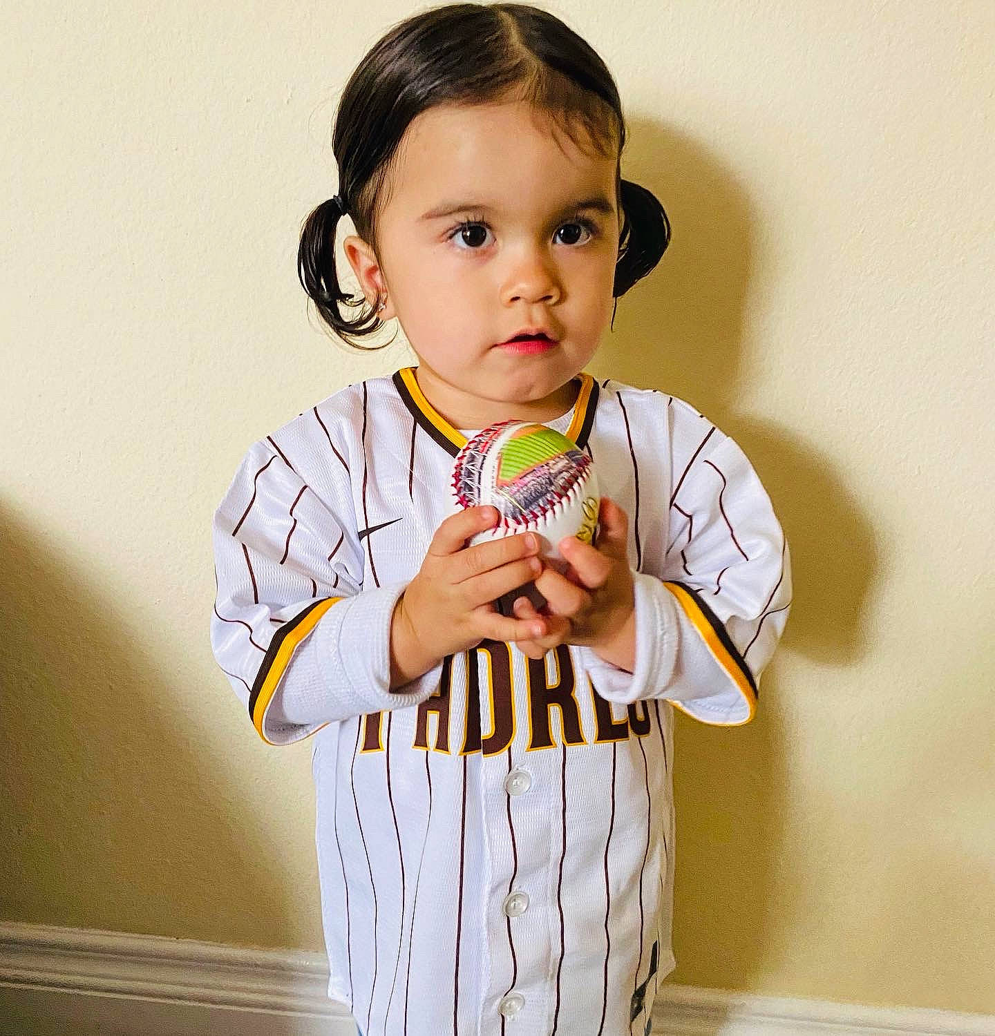 Angie joined the competition — help win amazing prizes! baby_toddler_clothing, clothing, collar, face, finger, gesture, hair, hand, happy, human_body, jersey, neck, outerwear, person, shoulder, sleeve, sports_jersey, sports_uniform, sportswear, t_shirt