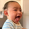 Dezi joined the competition — help win amazing prizes! baby, child, smiling, tongue_out, happy, striped_shirt, face, skin, hands, indoor, person, cute, infant, expression, joy, portrait, head, short_hair, light, blurred_background