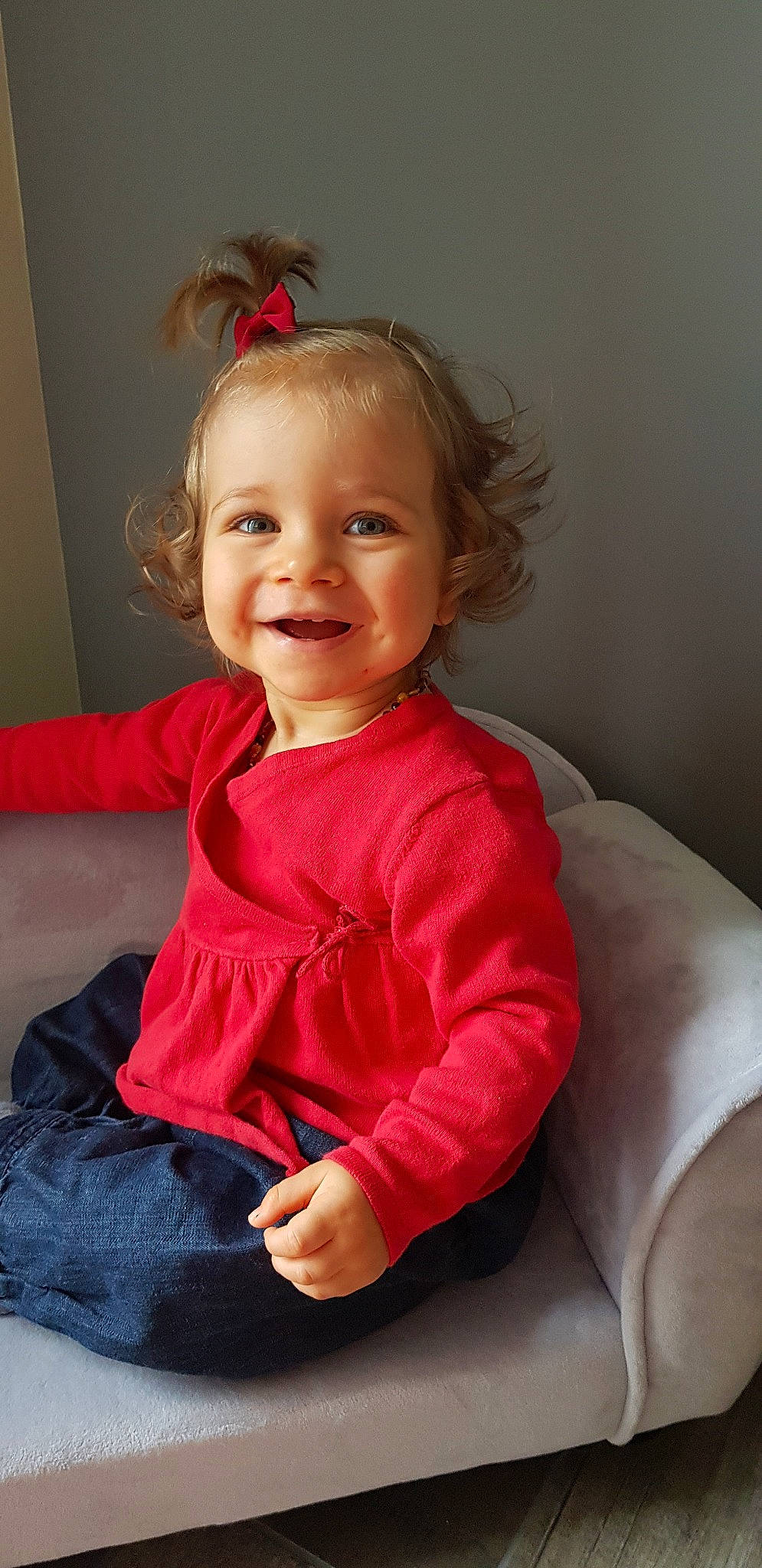 Daphnée participe au concours pour gagner de l'argent avec cette photo : arm, baby, cheek, child, face, finger, head, person, sitting, sleeve, smile, standing, toddler