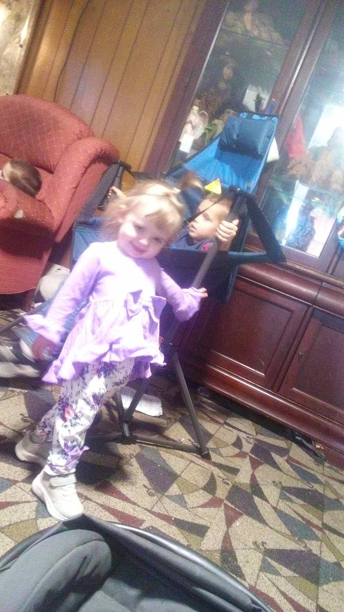 Hazel joined the competition — help win amazing prizes! boot, cabinetry, chair, child, comfort, drawer, floor, flooring, fun, hardwood, joy, lap, leisure, living_room, person, purple, room, sitting, sneakers, standing