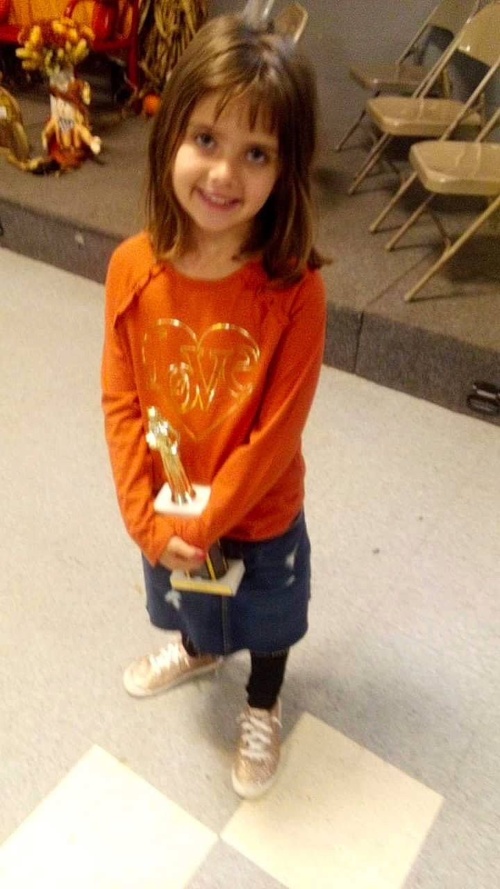 Allyssandra is registered to the contest to win money with this photo: baby_toddler_clothing, brown_hair, child, facial_expression, flooring, fun, hair, happy, human_leg, joy, knee, leisure, person, shoe, skin, sleeve, smile, sportswear, t_shirt, thigh