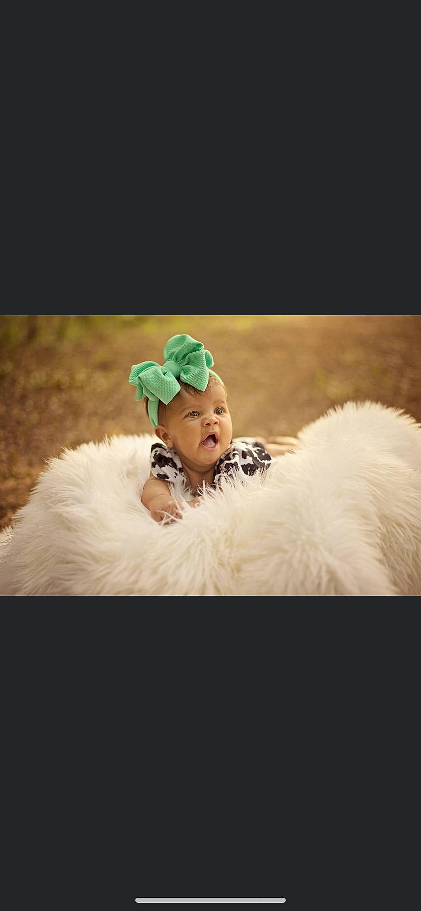 Khloe is registered to the contest to win money with this photo: baby, cap, cloud, entertainment, event, fashion_accessory, feather, fictional_character, flash_photography, fun, fur, fur_clothing, grass, happy, landscape, person, recreation, selfie, sitting, sky