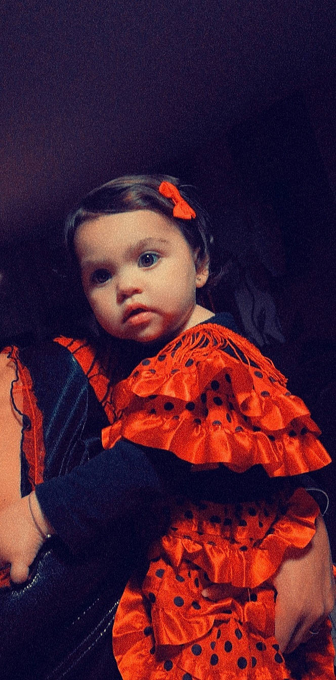 Lila participe au concours pour gagner de l'argent avec cette photo : art, baby, baby_toddler_clothing, cheek, child, chin, costume, eye, fashion_accessory, fashion_design, flash_photography, fun, iris, orange, pattern, person, ruffle, sitting, sleeve, tints_and_shades