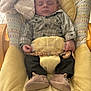 Mayron participe au concours pour gagner de l'argent avec cette photo : baby, infant, sleeping, plaid_shirt, dark_pants, baby_shoes, stuffed_animal, plush_toy, baby_seat, yellow_cushion, wooden_beads, clip, indoors, peaceful, child, person, cute, soft_toys, comfort, resting