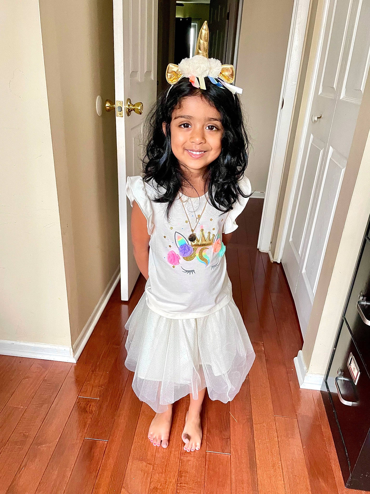Gia is registered to the contest to win money with this photo: abdomen, arm, baby_toddler_clothing, day_dress, door, face, flooring, happy, hardwood, hat, headband, iris, joy, person, sleeve, smile, thigh, toddler, trunk, waist