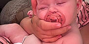 Logan joined the competition — help win amazing prizes! baby, infant, pacifier, hand, diaper, skin, sleepy, person, indoor, couch, striped_clothing, pink, flesh_tone, child, holding, relaxing, closeup, cute, comfort, soft
