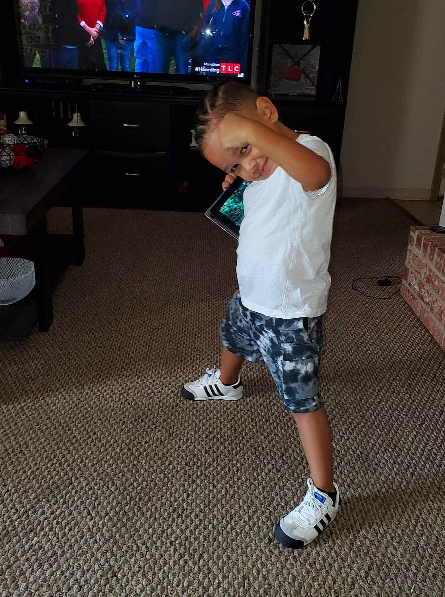 Zayden is registered to the contest to win money with this photo: child, floor, flooring, footwear, fun, human_leg, joint, joy, leg, person, play, shoe, shoulder, sportswear, standing, t_shirt, technology, toddler