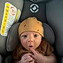 Grady joined the competition — help win amazing prizes! baby, infant, car_seat, hat, brown_clothing, finger, hand, face, eyes, mouth, expression, sitting, child, cute, indoors, safety_label, blanket, newborn, portrait, looking_up