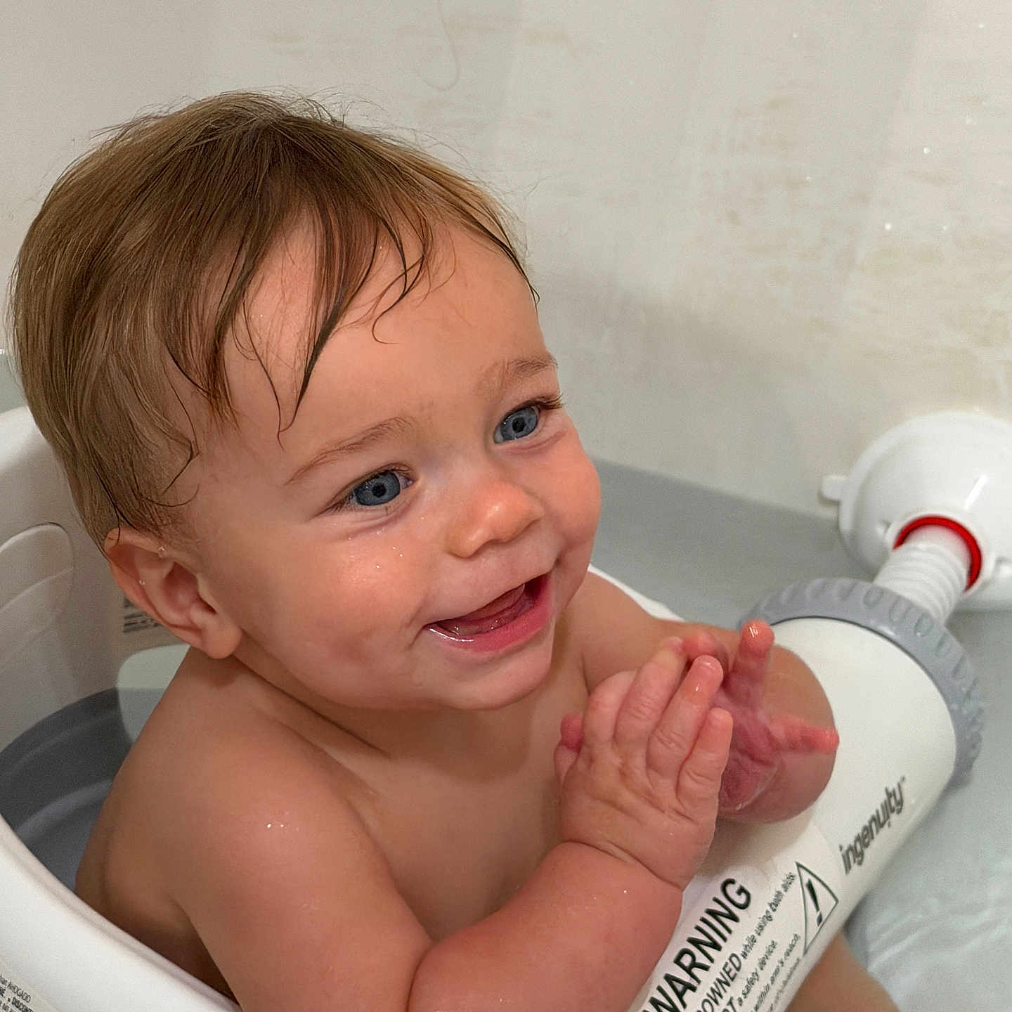 Oaklyn joined the competition — help win amazing prizes! baby, child, bath, bathtub, water, wet_hair, blue_eyes, smile, clapping_hands, skin, warning_label, bath_seat, sitting, joyful, cute, indoor, young_child, happy, closeup, person