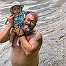 Oaklyn joined the competition — help win amazing prizes! man, baby, water, river, hat, glasses, tattoo, beard, swimming, child, outdoor, summer, holding, portrait, barechested, smile, parent, family, nature, sunhat