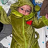 Oaklyn is registered to the contest to win money with this photo: baby, child, onesie, green_clothing, heart_patch, blanket, clothes, pile, infant, cute, lying_down, soft_texture, hooded_suit, baby_face, indoor, portrait, colorful, casual, cozy, warm