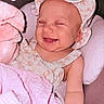 Marion is registered to the contest to win money with this photo: baby, baby_clothes, blanket, closeup, clothing, cushion, cute, fabric, face, happy, hat, indoors, infant, infant_baby, newborn, person, pink, relaxing, seat, smiling