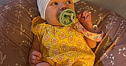 Marion joined the competition — help win amazing prizes! baby, pacifier, headwrap, bow, yellow_outfit, floral_pattern, white_shoes, lace, cushion, playpen, indoors, infant, cute, child, baby_clothes, footwear, sitting, looking_sideways, comfort, baby_accessories