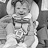 Marion joined the competition — help win amazing prizes! baby, infant, car_seat, smiling, headband, bow, shoe, sock, straps, cute, child, portrait, seat, clothing, happy, person, black_and_white, indoors, baby_girl, expression