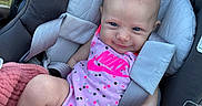 Marion is registered to the contest to win money with this photo: baby, baby_clothes, baby_fashion, car_seat, cheeky_smile, chicco, child, cute, grass_background, head_support, infant, infant_care, nike_logo, outdoor, pink_clothing, polka_dots, safety_harness, seat_belt, smiling, sunlight