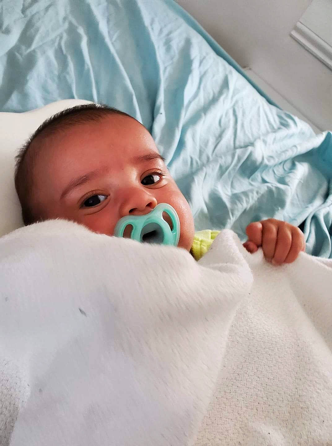 Emiliano is registered to the contest to win money with this photo: baby, bedtime, birth, blanket, child, childbirth, mouth, nose, person, room