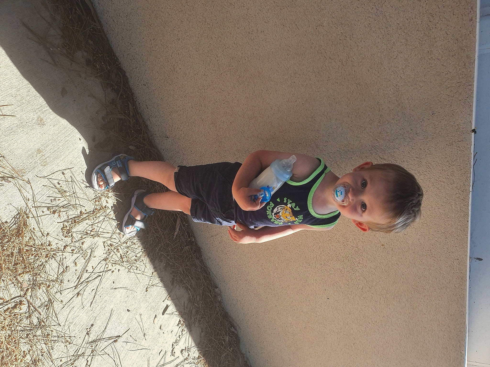 Adrian participe au concours pour gagner de l'argent avec cette photo : asphalt, baby, baby_toddler_clothing, child, concrete, elbow, foot, fun, human_body, human_leg, knee, leg, leisure, person, sandal, shadow, sitting, sock, thigh, toddler