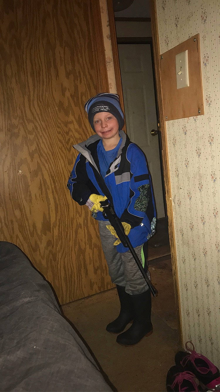 Luke is registered to the contest to win money with this photo: blue_collar_worker, boot, construction_worker, costume, door, electric_blue, flooring, fun, hat, headwear, helmet, joy, person, personal_protective_equipment, recreation, tool, tree, uniform, wood, workwear