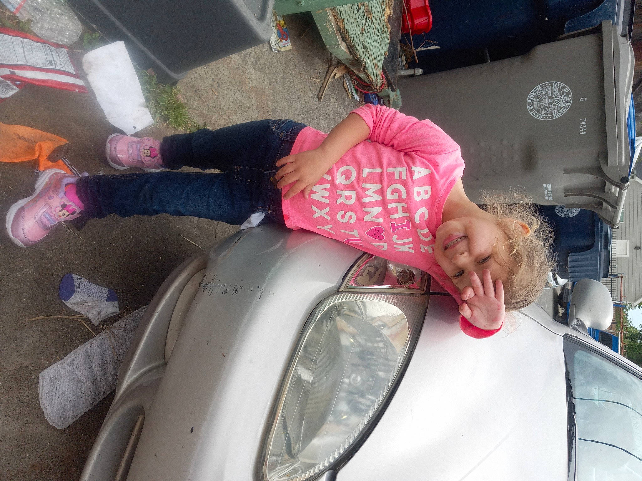 Elissa is registered to the contest to win money with this photo: alloy_wheel, automotive_design, automotive_exterior, automotive_lighting, automotive_tail_brake_light, automotive_tire, bumper, car, fender, headlamp, headwear, hood, joy, light, motor_vehicle, person, photograph, pink, tire, trunk