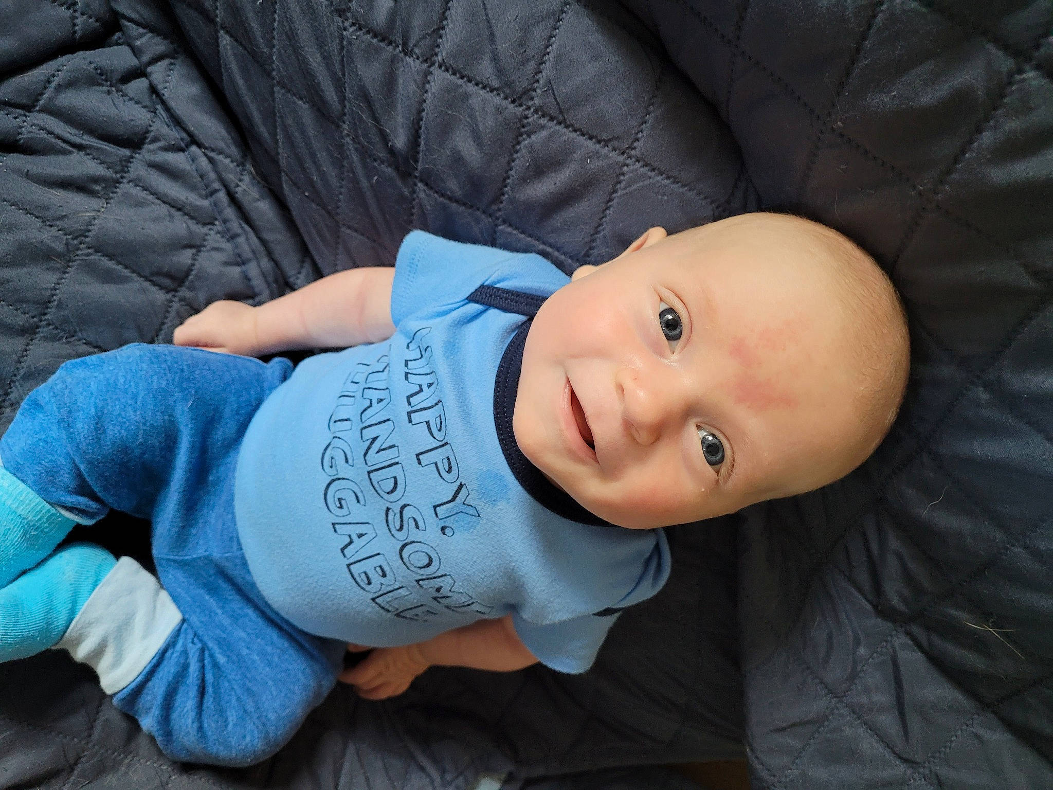 Cayden is registered to the contest to win money with this photo: baby, baby_toddler_clothing, cheek, comfort, cool, denim, elbow, electric_blue, flash_photography, grass, happy, mammal, outerwear, person, sitting, skin, sleeve, smile, t_shirt, toddler