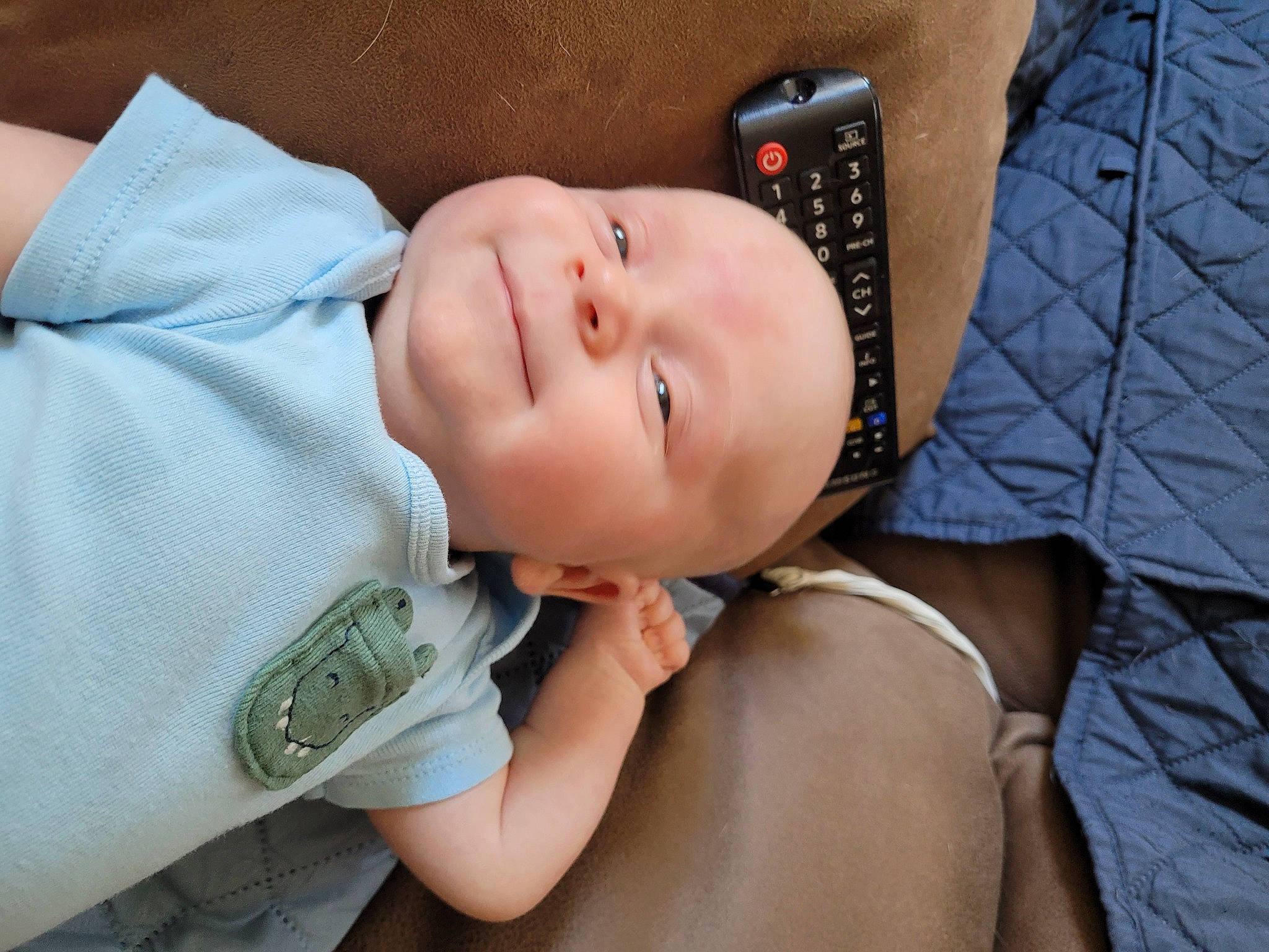 Cayden is registered to the contest to win money with this photo: baby, baby_toddler_clothing, cheek, chest, comfort, elbow, eye, eyelash, face, grass, happy, hat, lip, mouth, neck, nose, person, skin, sleeve, smile